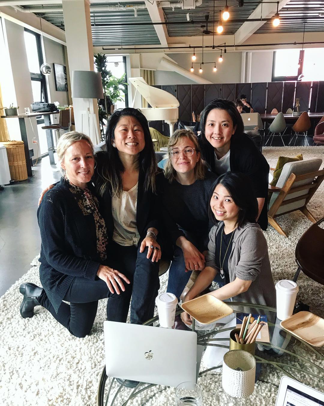 Molly Hawkins with her team in a studio workspace